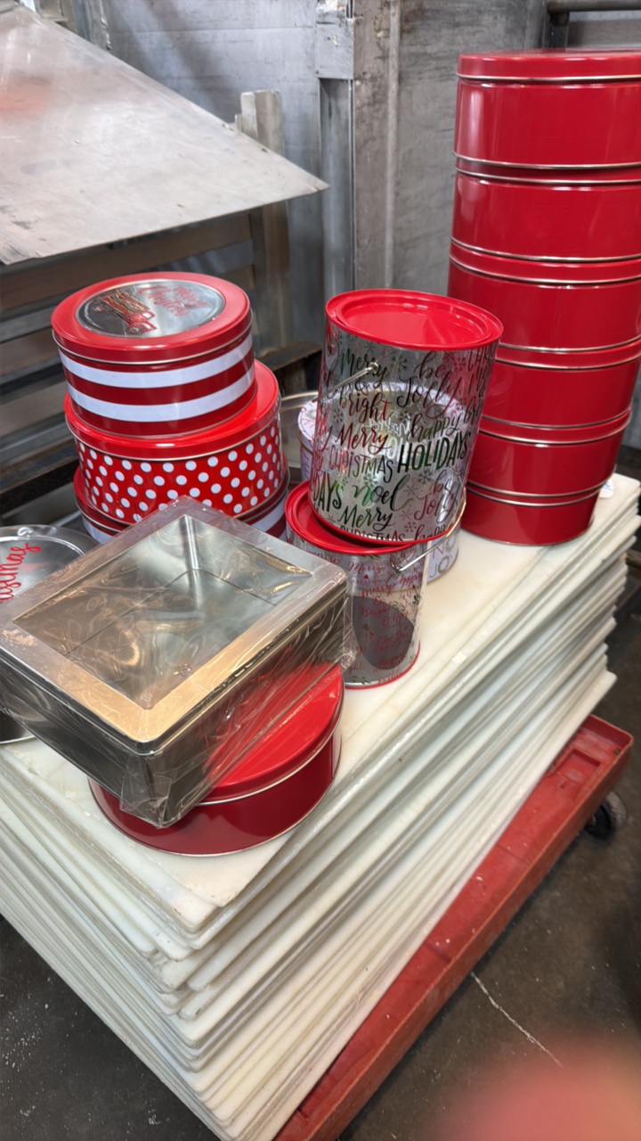 assorted Christmas tins and pails