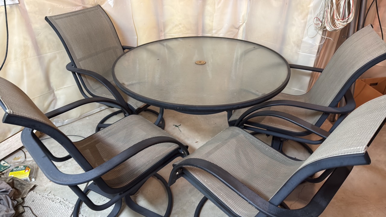 Glass top patio set with four chairs