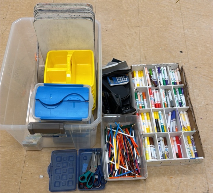 lot of calculators markers, colored pencils, scissors, small whiteboards