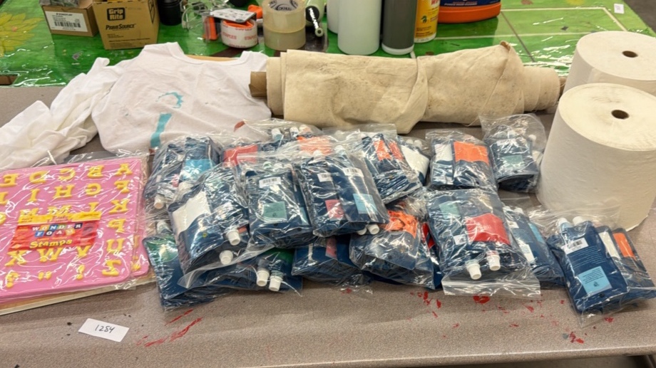 brand new bags of fabric, paint, paper towels, fabric, and letter stamps