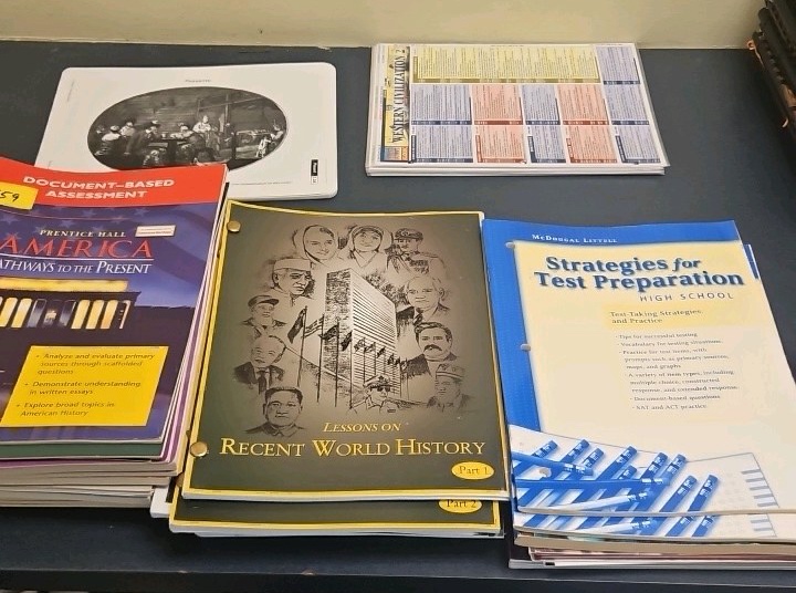 assortment of History workbooks and study guides