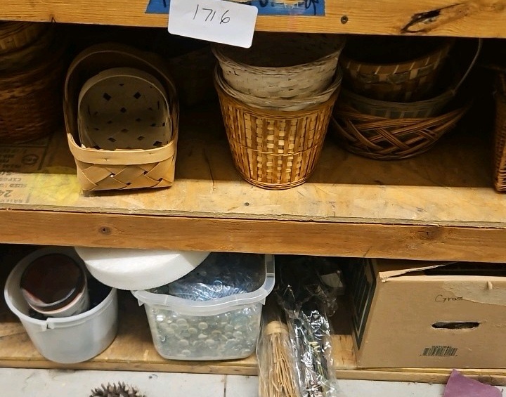 two shelves of baskets and decorative rocks