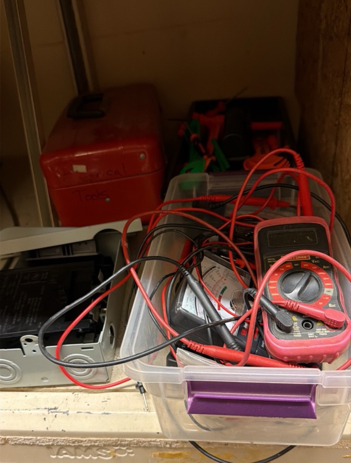 shelf of multimeter light switches nails in tote of leather materials