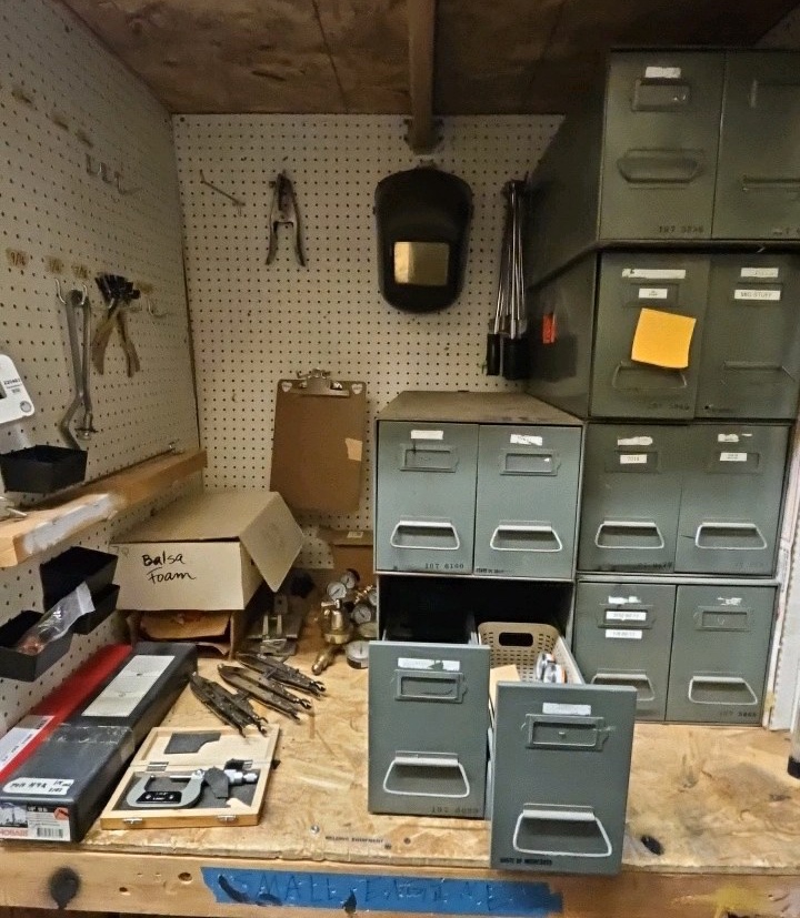 shelf of welding supplies and measuring instruments