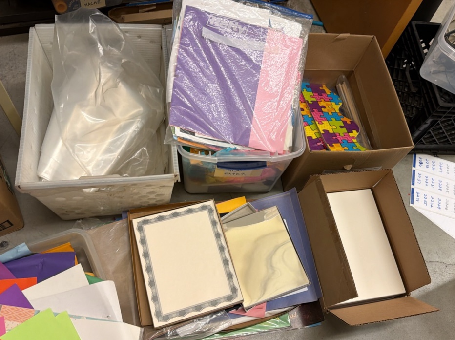 construction paper, various new packs of paper, tissue paper, and clear bags
