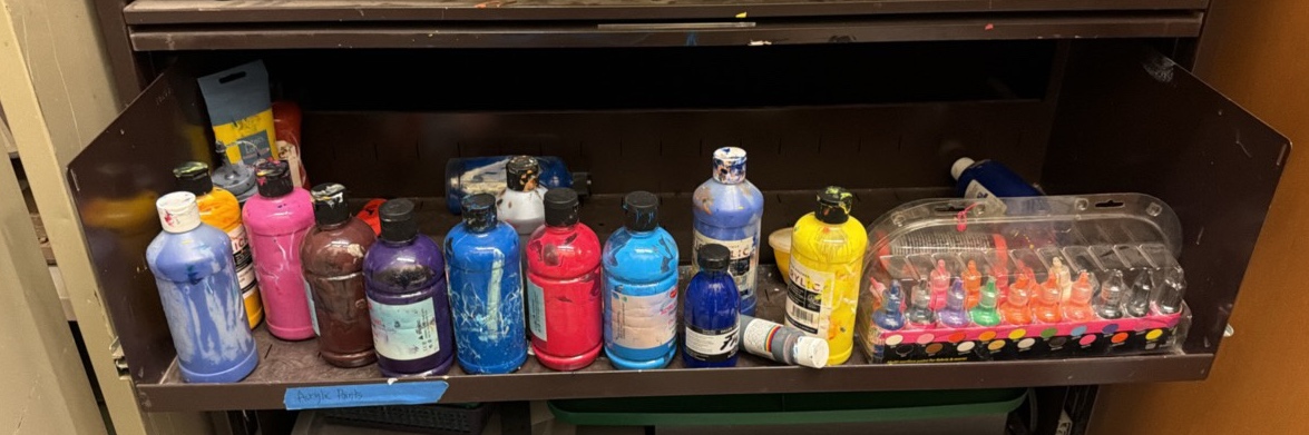 shelf of acrylic paints