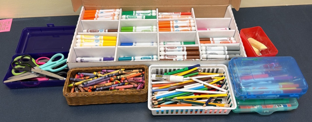 A lot of markers, scissors, crayons, and colored pencils