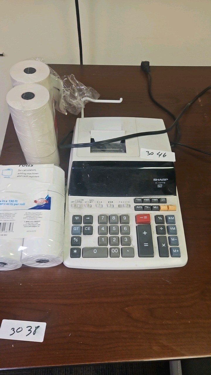 sharp desktop calculator with printer rolls