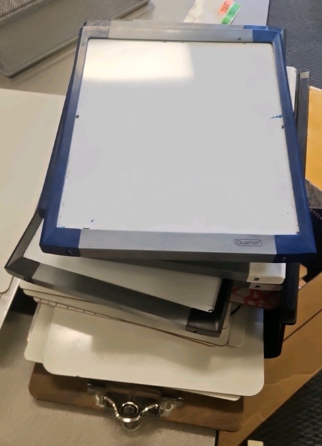 assortment of clipboards and dry erase boards