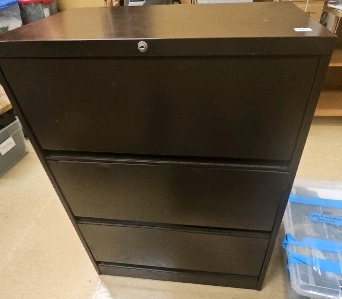 metal filing cabinet full of curriculum and plays
