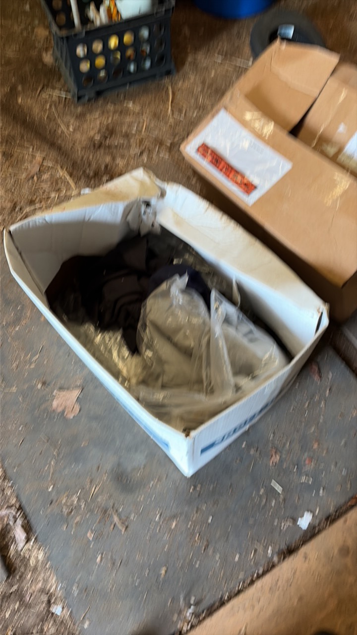 Two boxes containing various shirts.