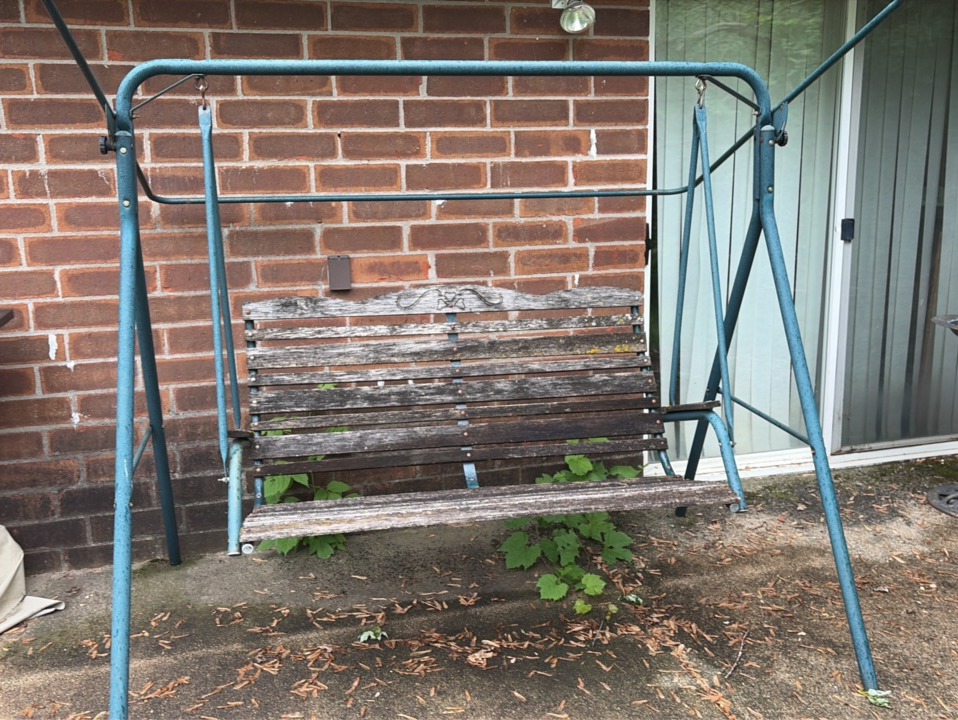 Outdoor swing with wooden bars and metal