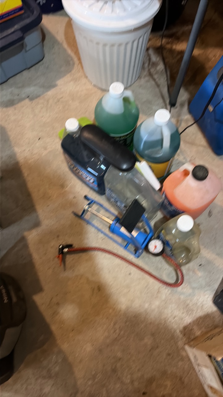 A lot of car supplies, including car wash, pump, and Pro Lift mat.