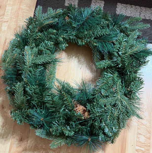NearlyNature wreath with white lights and pine cones. Lights are battery powered with onofftimer
