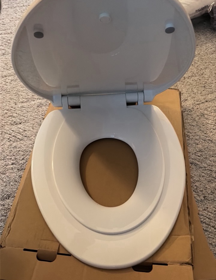 white elongated toilet seat with child seat insert and hardware
