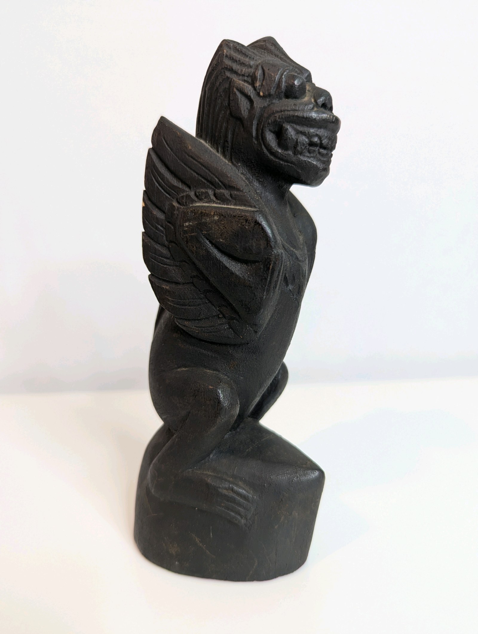 Vintage, hand-carved wooden figurine reminiscent of Balinese or Southeast Asian mythology