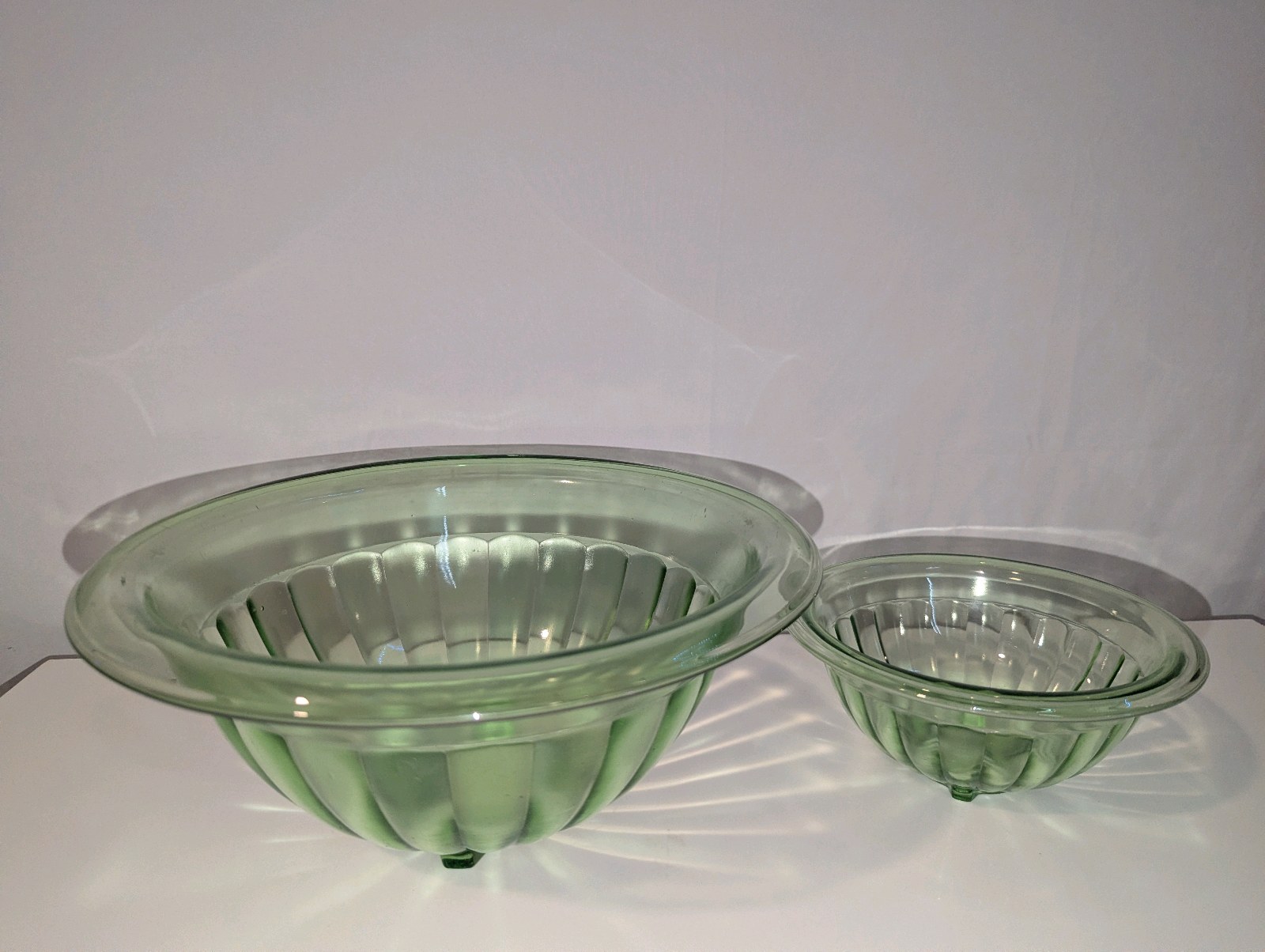 Vintage green depression glass mixing bowls, glow under uv