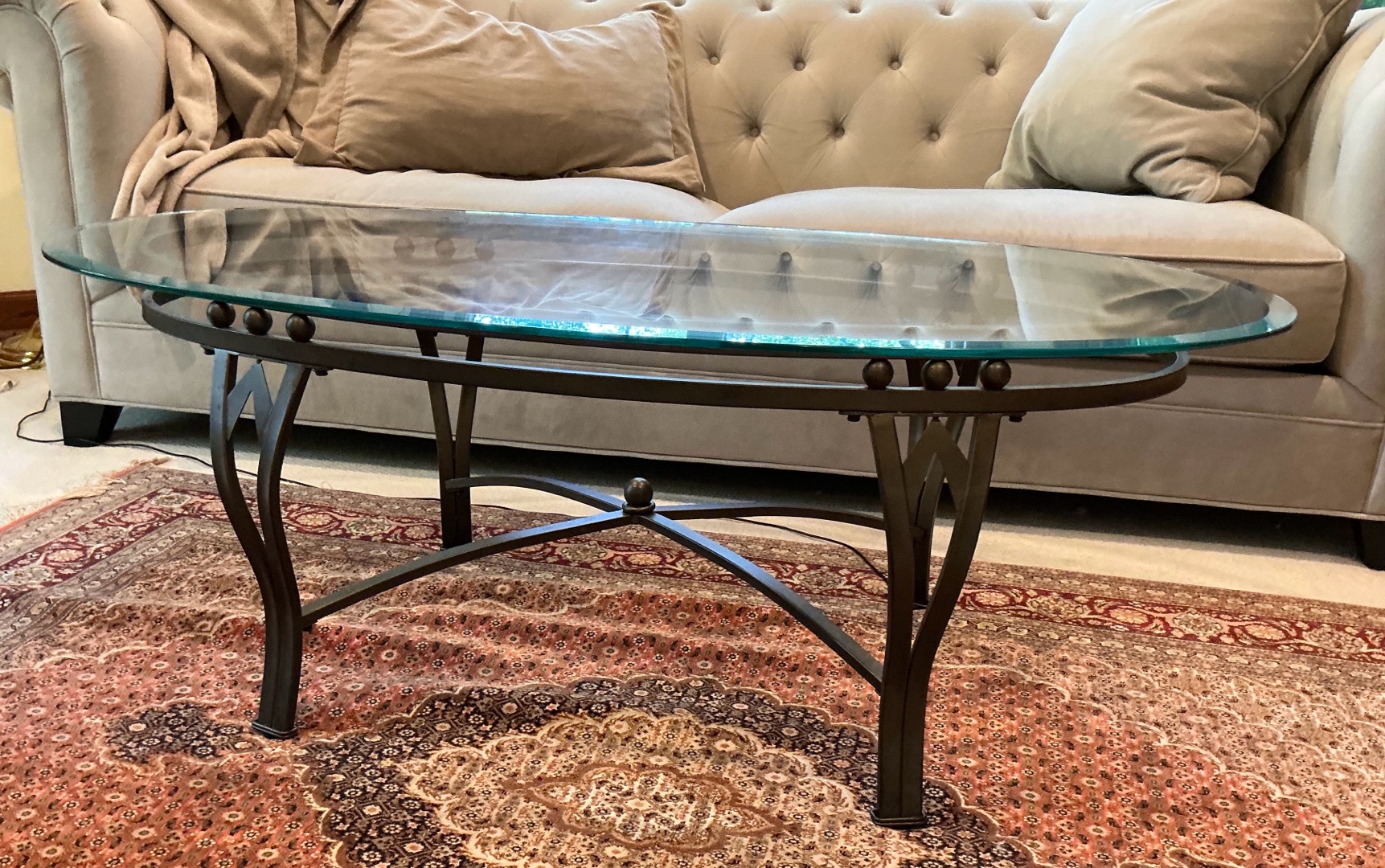 Wrought iron oval coffee table with beveled glass top