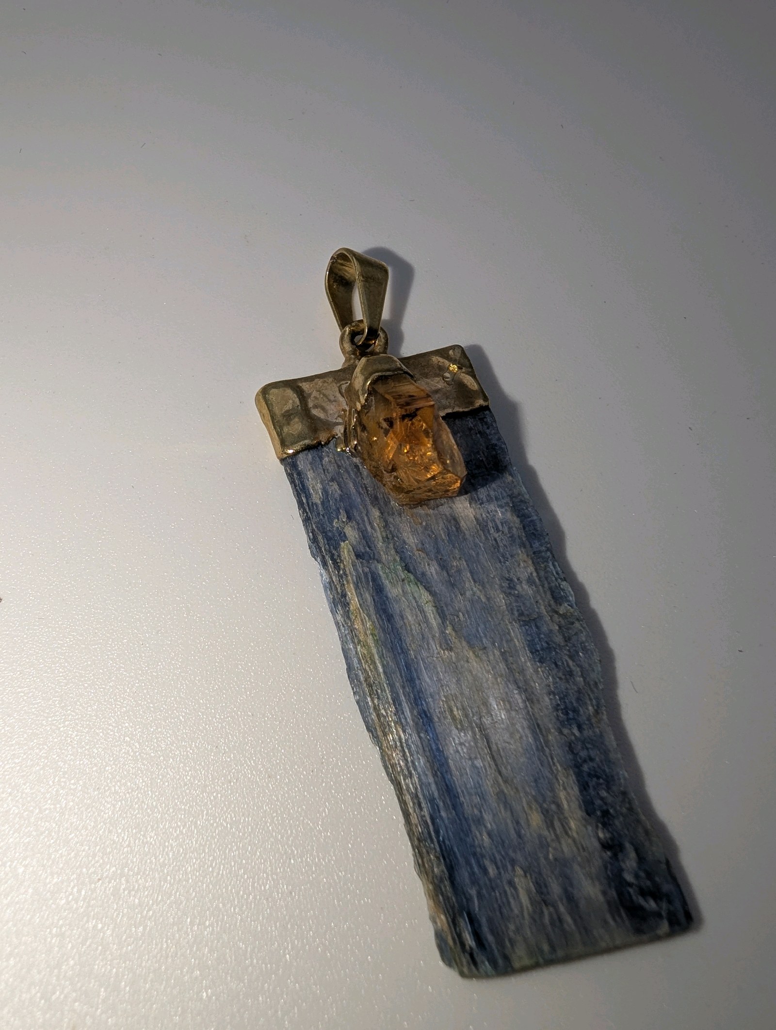 Raw blue kyanite and citrine point pendant, gold plated top