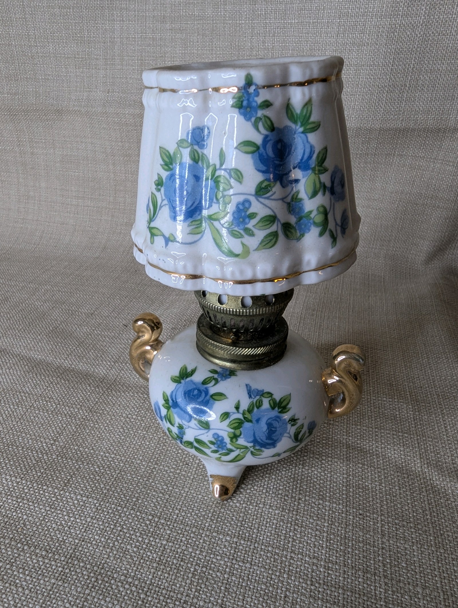 Vintage Royal Crown miniature oil lamp featuring hand-painted blue floral motifs and gold trim