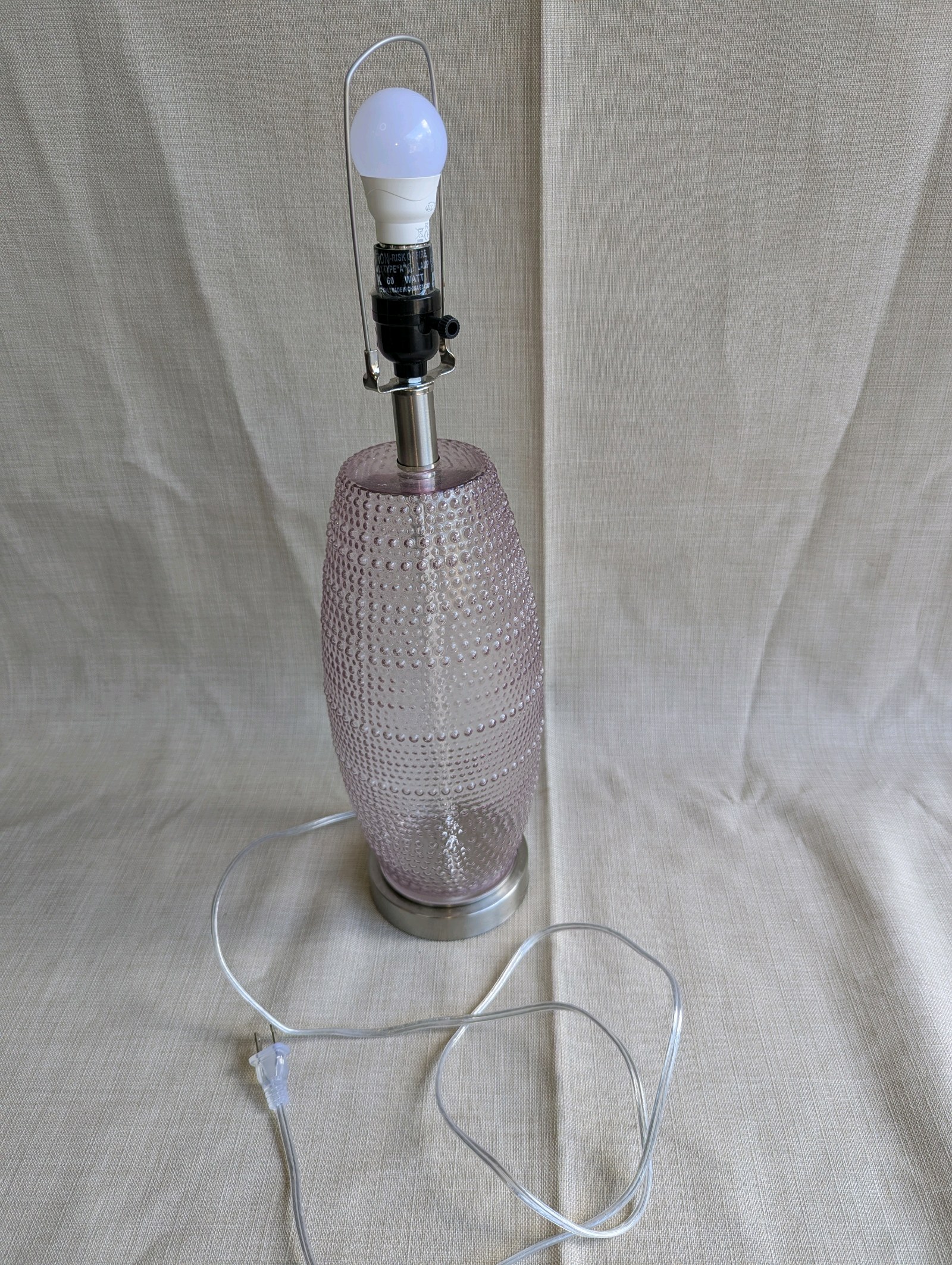 At Home x Grace Mitchell Ribbed Glass Table Lamp with a distinctive pink textured base, pink led lightbulb