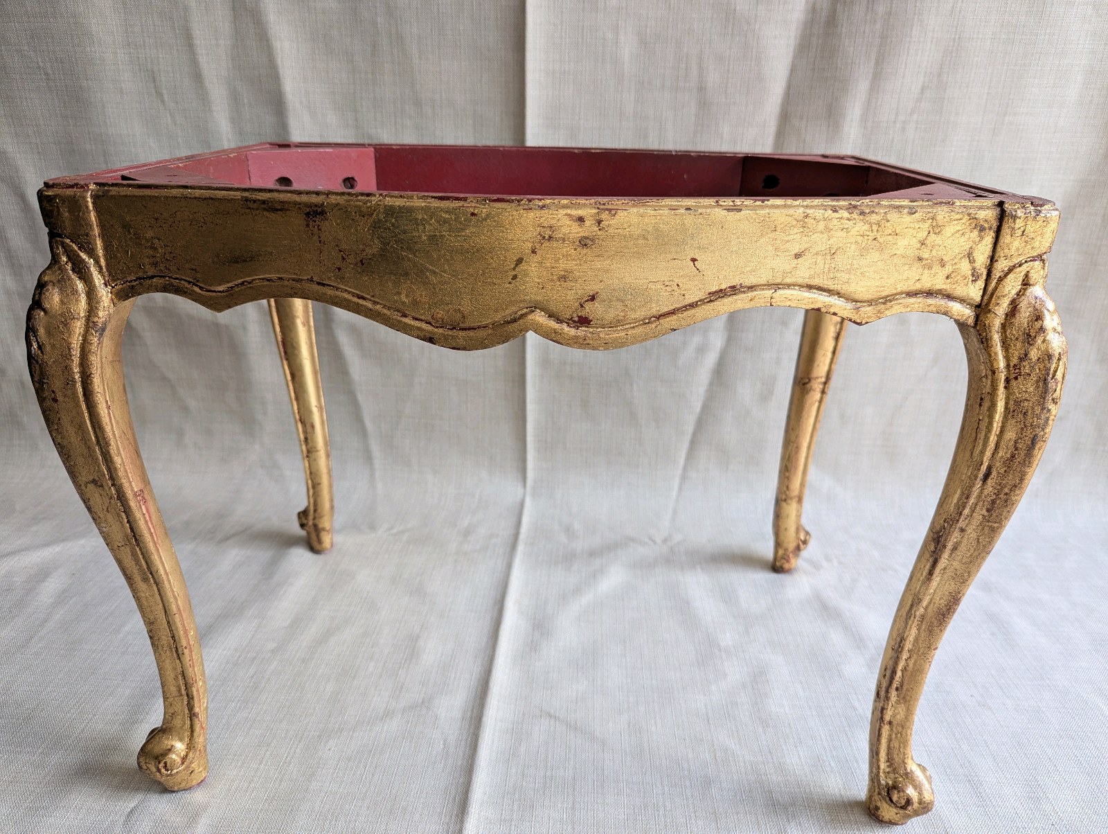 Italian Florentine side table from the 1950s,distinctive weathered gold gilt finish over a red base