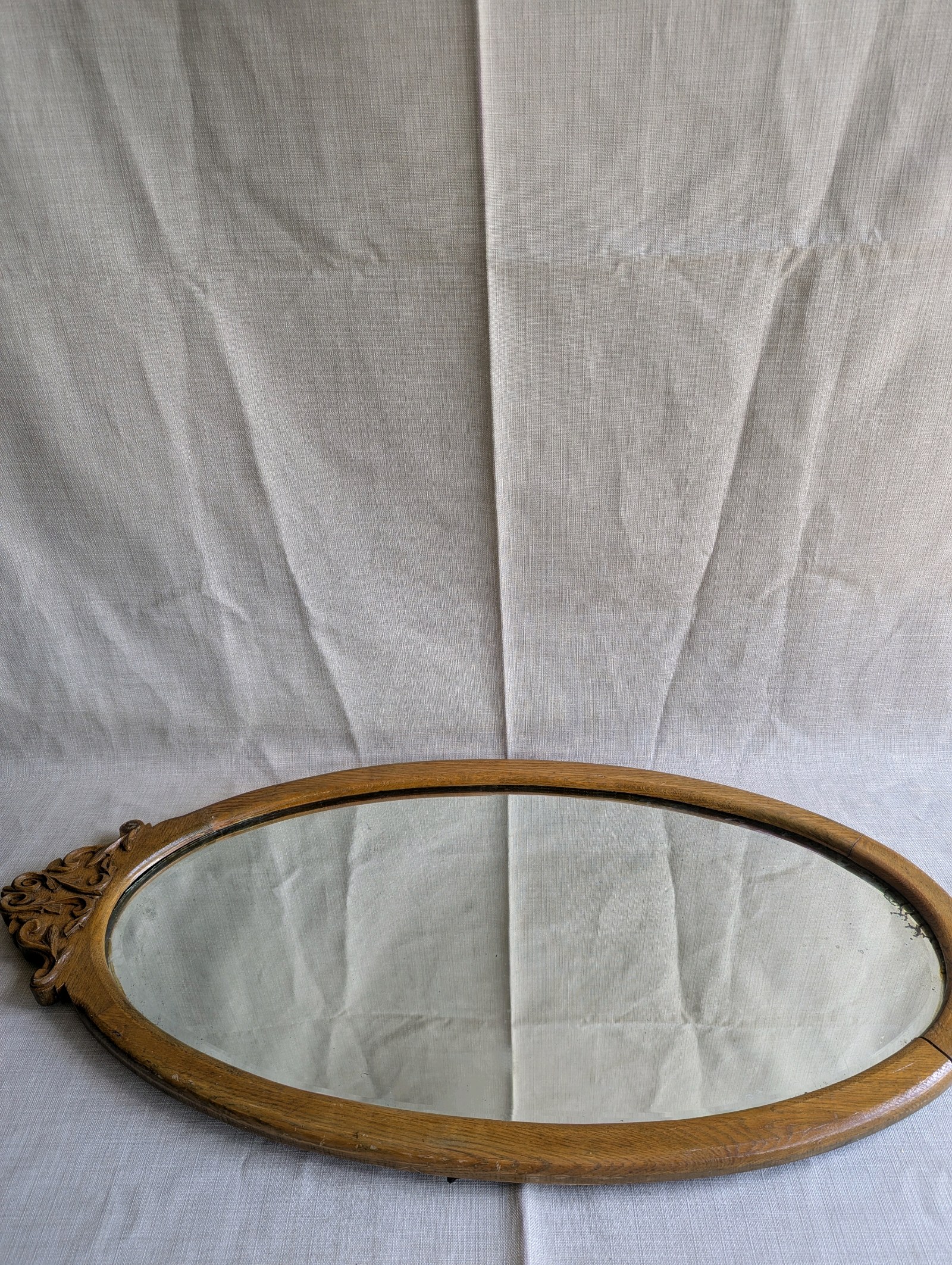 Antique Victorian wall mirror, beautifully carved oak frame and a distinct oval design