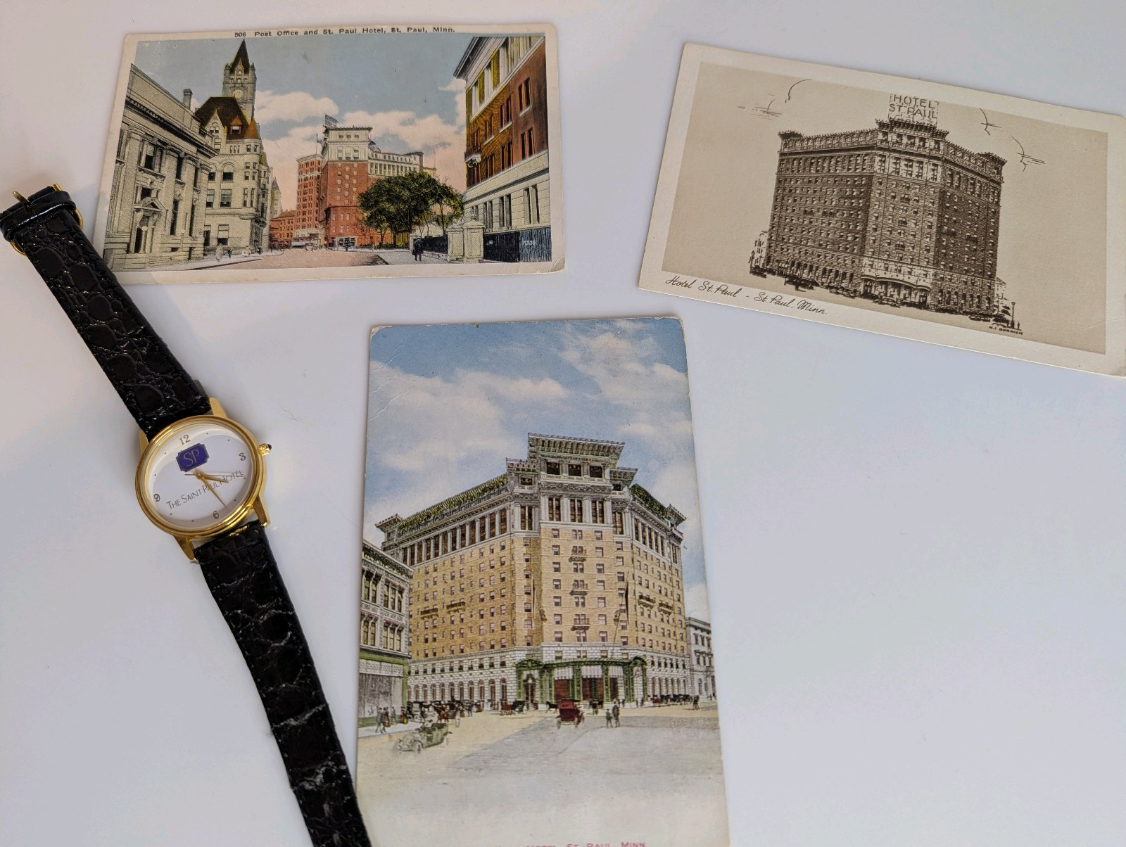 Vintage postcards and a souvenir watch highlighting The Saint Paul Hotel in Saint Paul, Minnesota