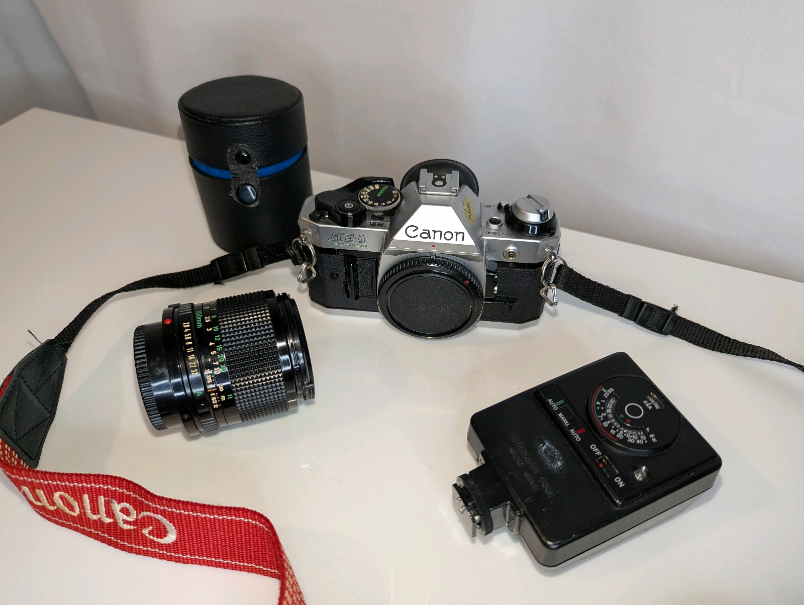 Vintage Canon AE-1 Program 35mm film SLR camera, Canon FD 100mm f2.8 telephoto lens, Canon Speedlite 188A electronic flash unit
